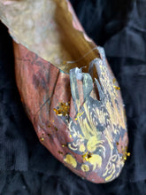 A handmade paper shoe with Swarovski crystals.