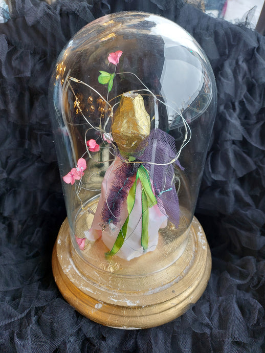 Paper dress in a dome with lights.